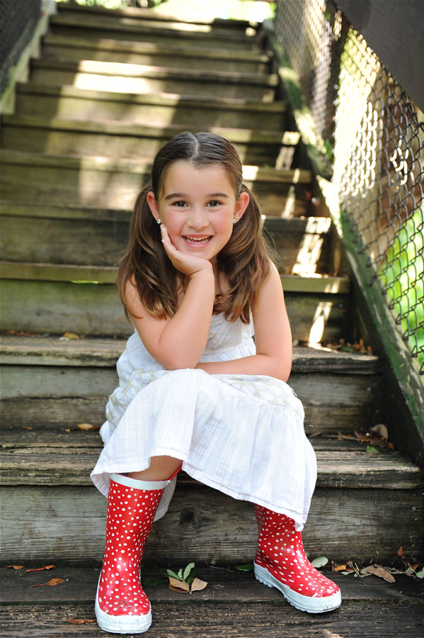 Little girl sitting on steps, portrait Stock Photo 