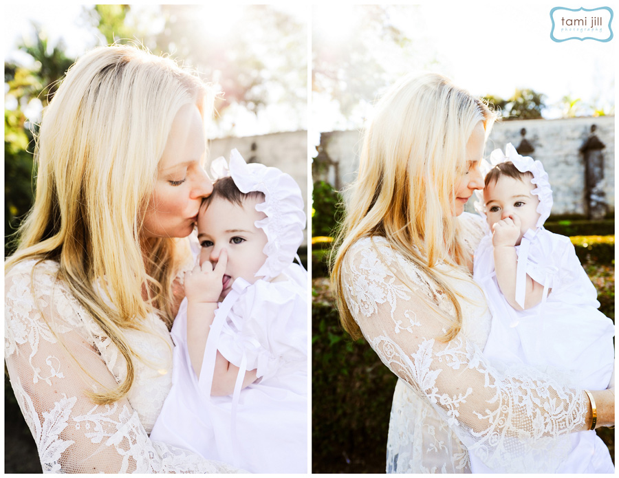 Mother and daughter natural photo. Mother kissing baby at a Baptism at Spanish Monastery in Miami.