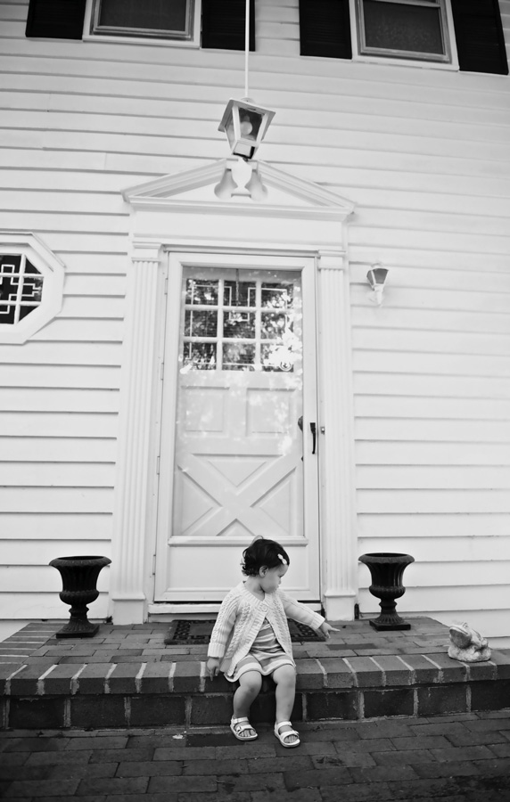 Little girl sits on her front step during this child photography session in Miami.