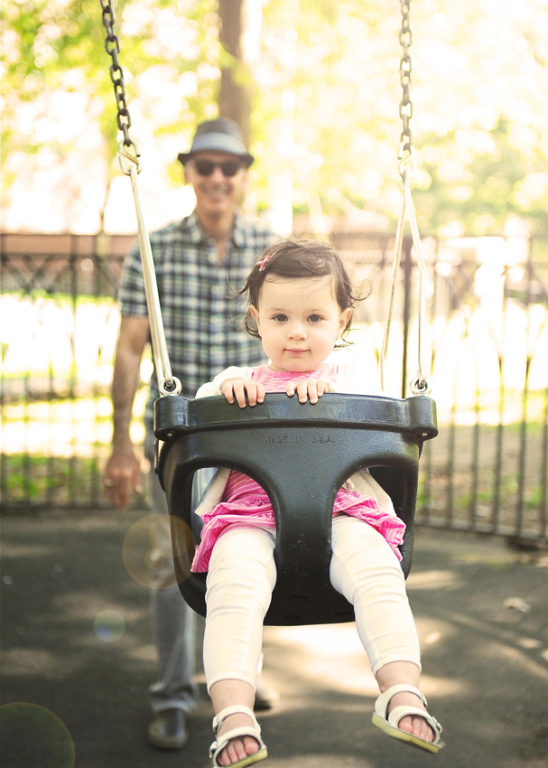 Grandpa pushes baby in the swing in this adorable miami baby photography session.