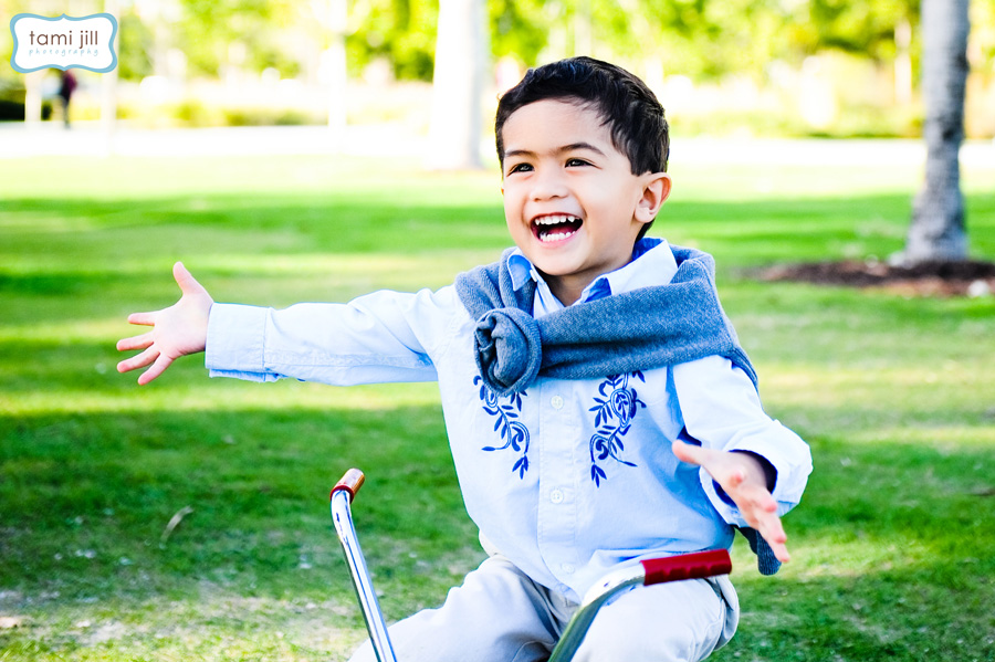 Little boy plays on bike during a Miami Lifestyle Photo Shoot.