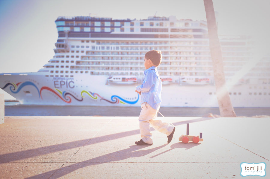 Boys watches cruise ship take off in miami.