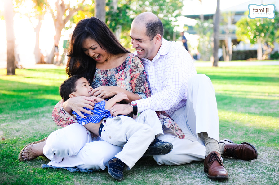 Family laughs at South Point Park during photography session.