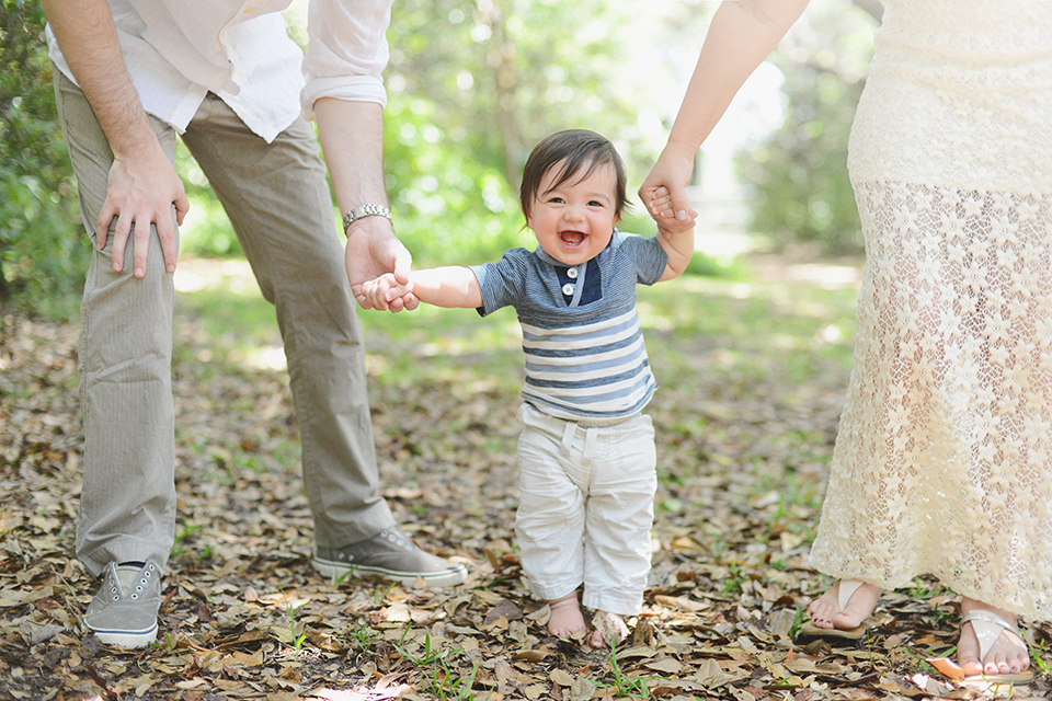 Baby holding hands with mommy during Miami photography session.