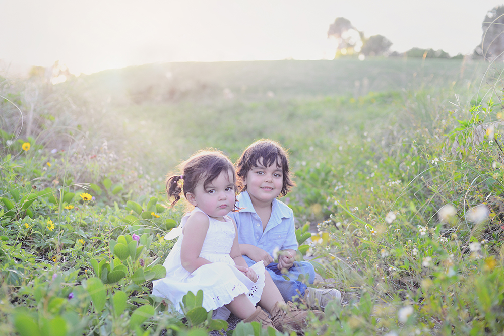 Children sitting in the beach dunes at South Point Park.