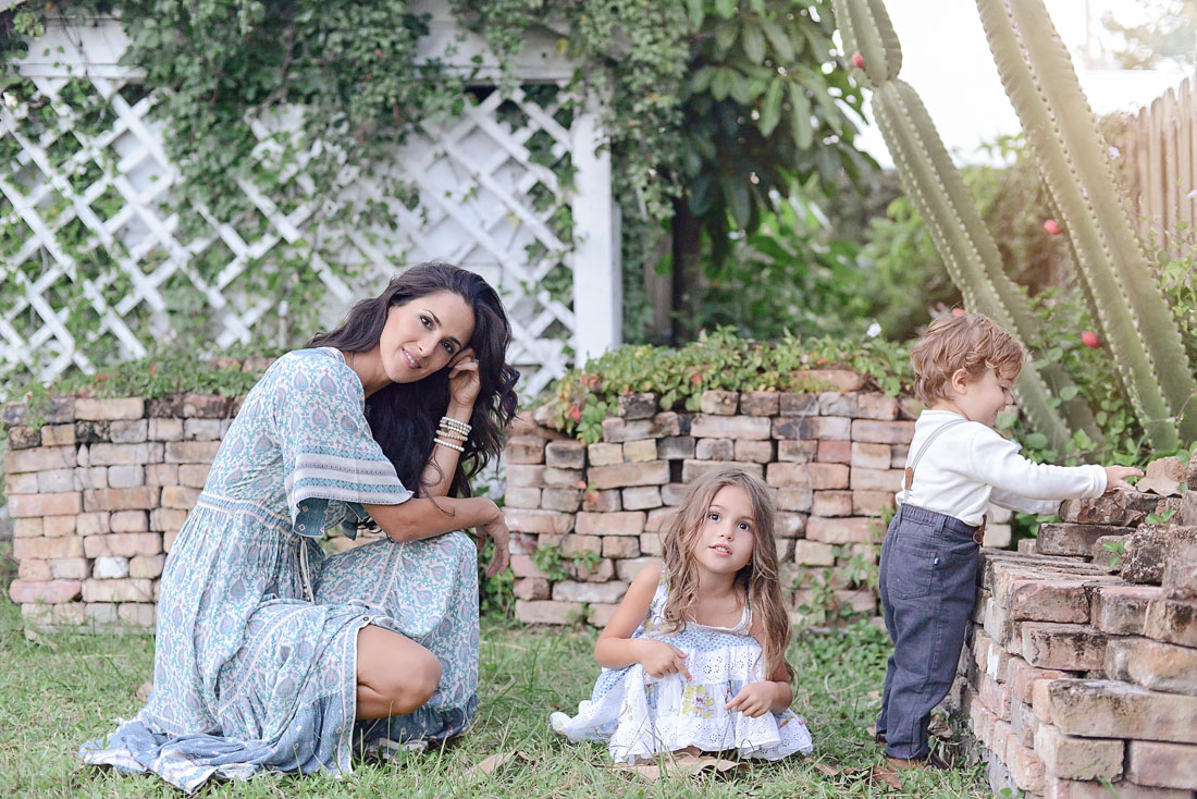 Mother and children play in backyard.