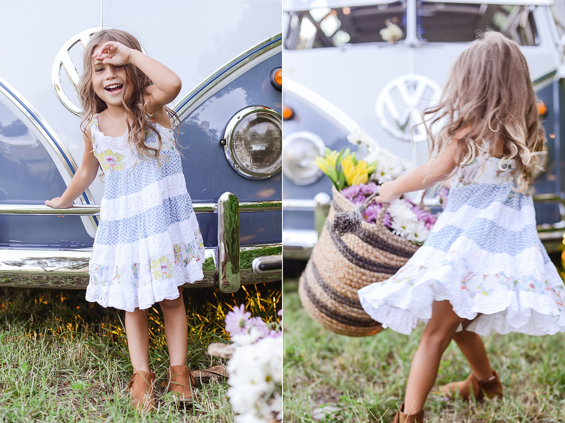 Child laughing by a vintage VW Bus.